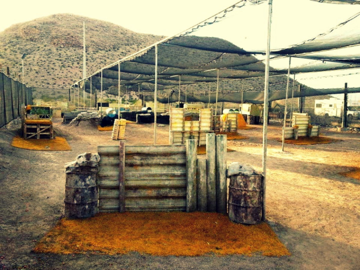 a truck driving down a dirt yard