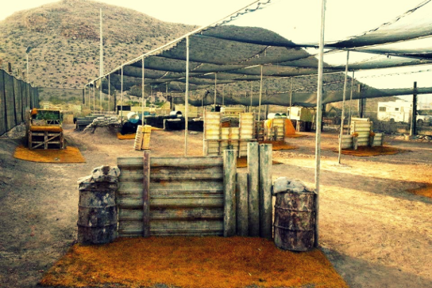 a truck driving down a dirt yard