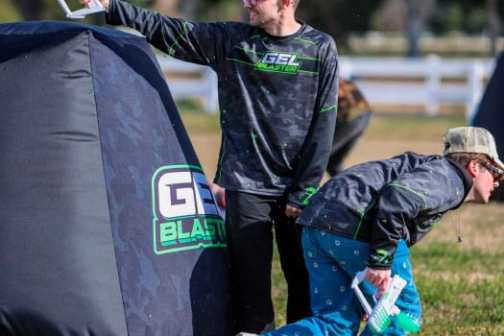 a man that is standing in the grass