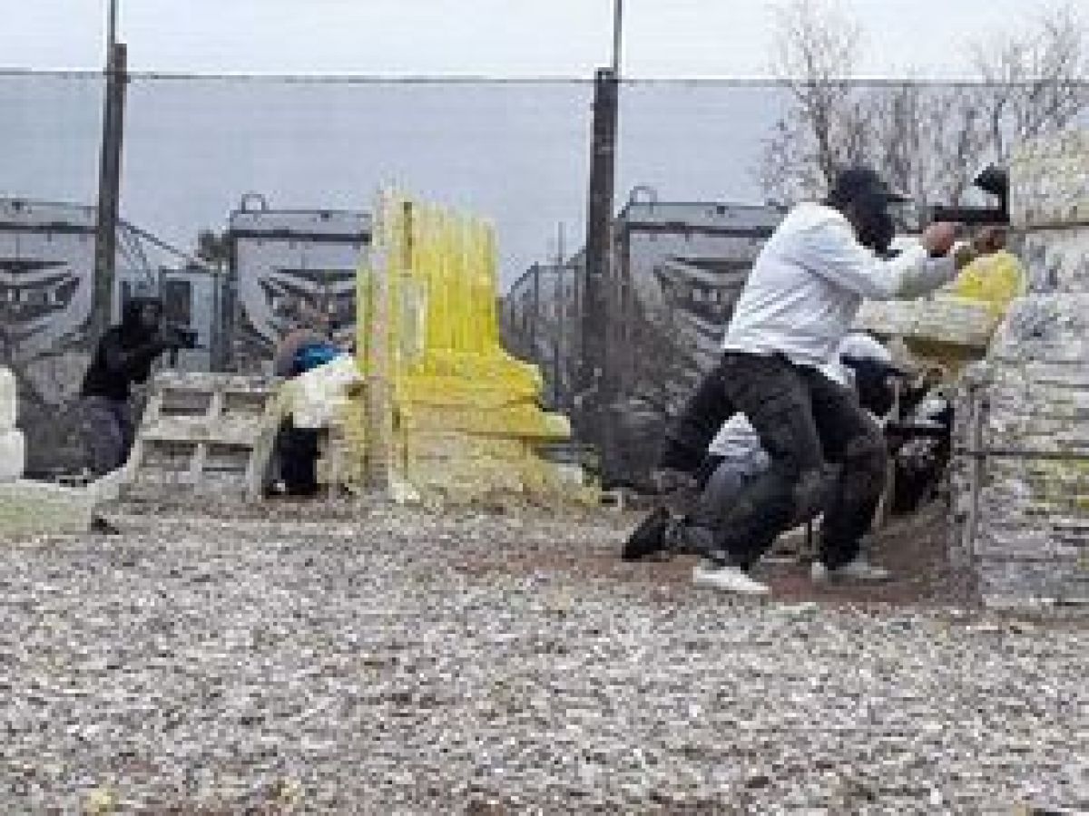 a man sitting on top of a dirt field