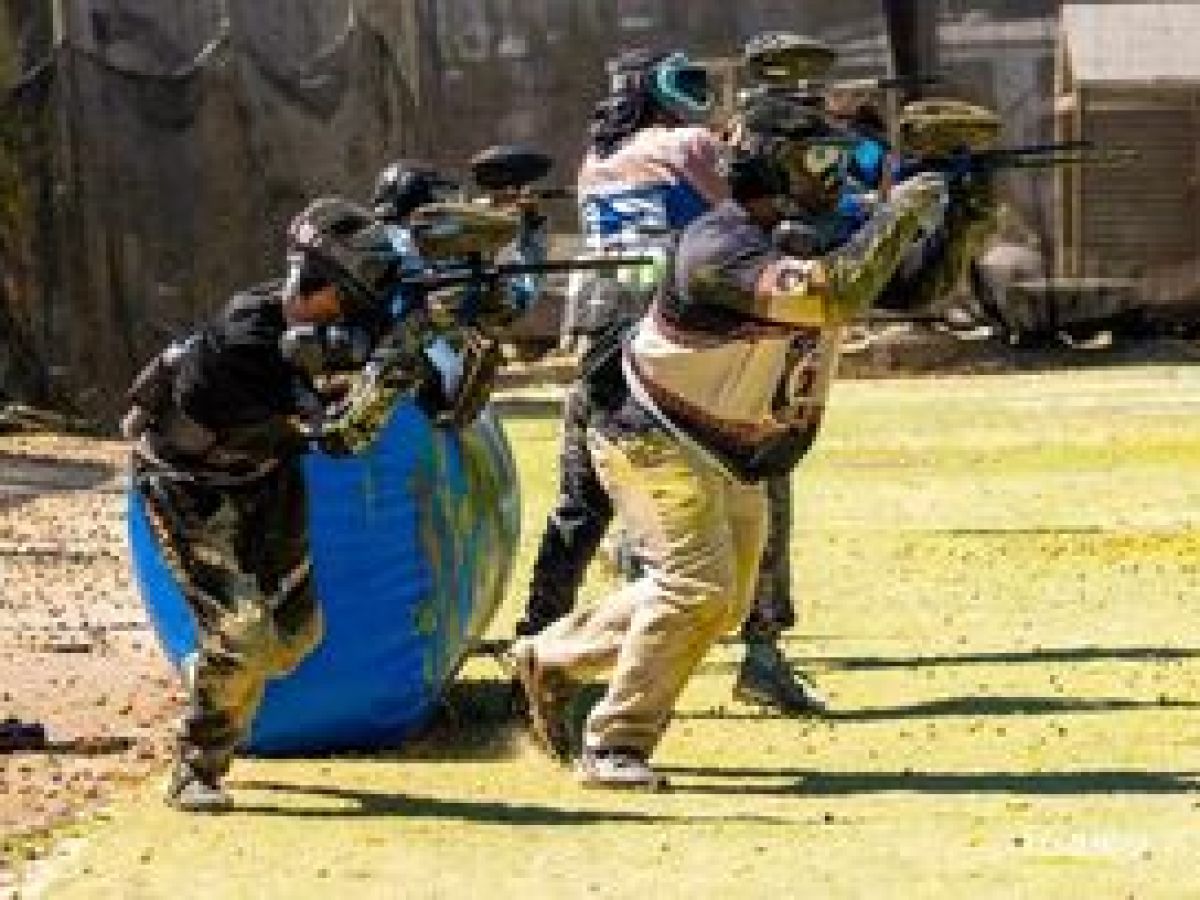 a group of people walking down a dirt road