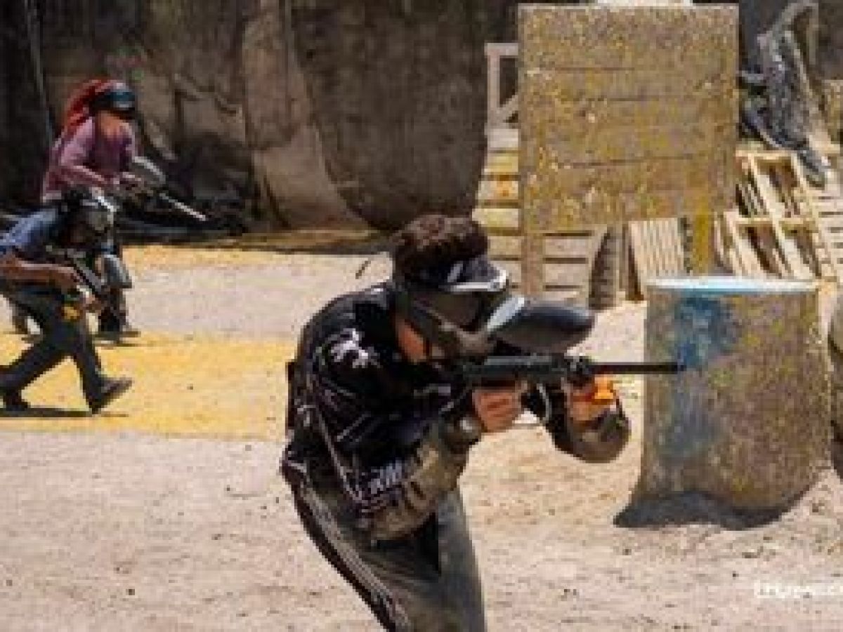 a person riding a motorcycle down a dirt road