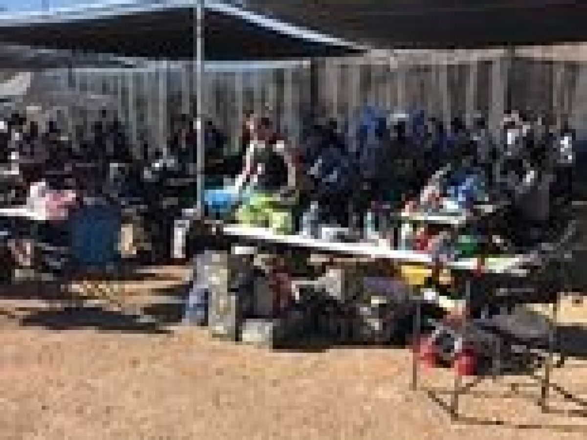 a group of people standing in the dirt