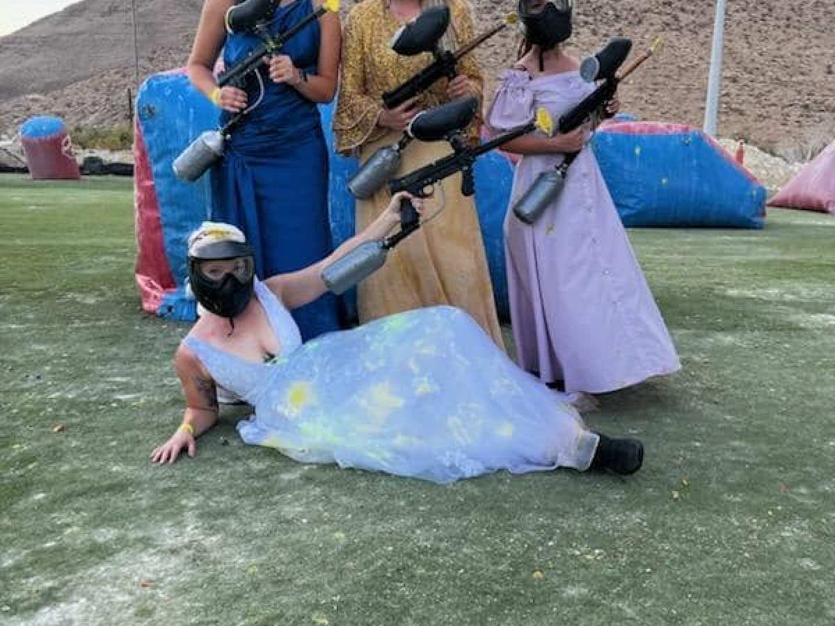 a group of people sitting in the grass