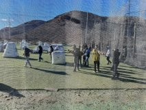 a group of people standing next to a fence